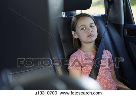 Stock Image - Girl wearing seat belt. Fotosearch