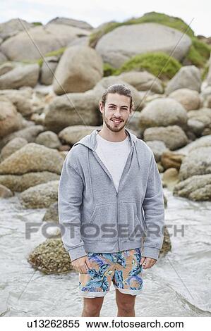 Man on beach smiling towards camera View Large Photo Image Stock Photography - Man on beach smiling towards camera. Fotosearch