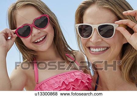 Mother and daughter wearing sunglasses View Large Photo Image Stock Photo - Mother and daughter wearing sunglasses. Fotosearch