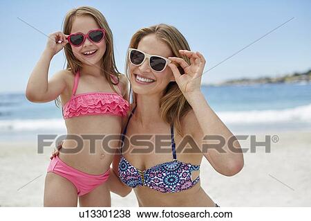 Mother and daughter wearing sunglasses View Large Photo Image Stock Photo - Mother and daughter wearing sunglasses. Fotosearch