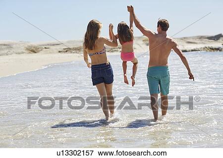 Mother and father lifting daughter View Large Photo Image Stock Photo - Mother and father lifting daughter. Fotosearch