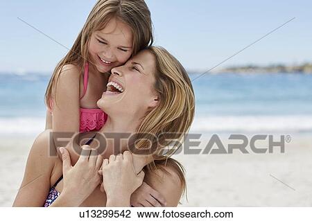 Mother carrying daughter on back View Large Photo Image Stock Image - Mother carrying daughter on back. Fotosearch