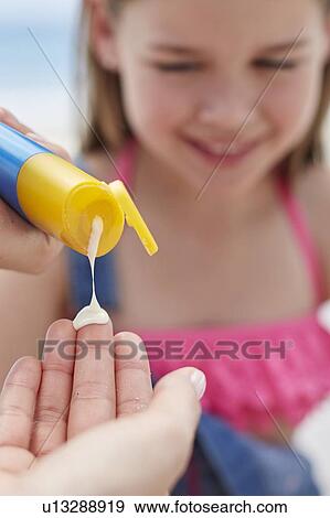 Person applying sun cream to a girl View Large Photo Image Stock Photo - Person applying sun cream to a girl. Fotosearch