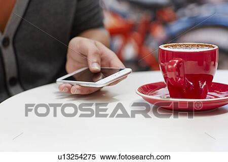 Person using smartphone with coffee View Large Photo Image Stock Photography - Person using smartphone with coffee. Fotosearch