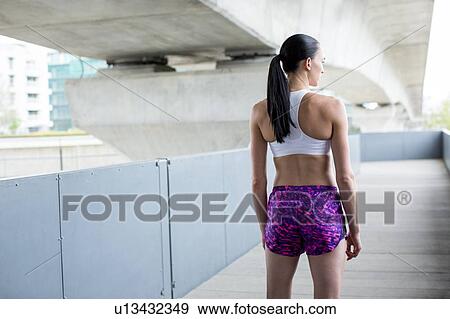 Stock Photo - Portrait of Woman in crop top and shorts. Fotosearch