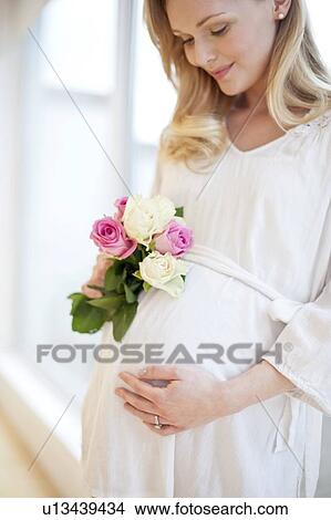 Pregnant woman holding posy of flowers View Large Photo Image Picture - Pregnant woman holding posy of flowers. Fotosearch