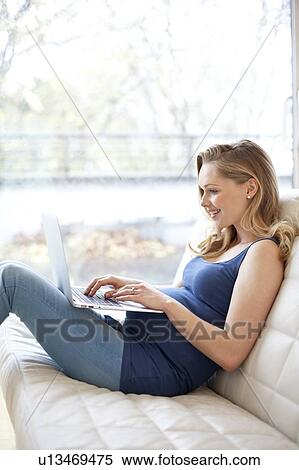 Stock Photography - Pregnant woman using laptop. Fotosearch