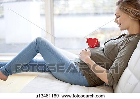 Pregnant woman with heart shape on tummy View Large Photo Image Stock Photo - Pregnant woman with heart shape on tummy. Fotosearch