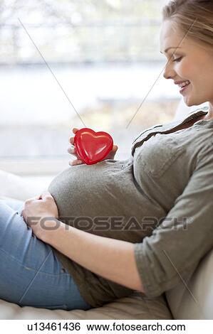 Pregnant woman with heart shape on tummy View Large Photo Image Stock Photograph - Pregnant woman with heart shape on tummy. Fotosearch