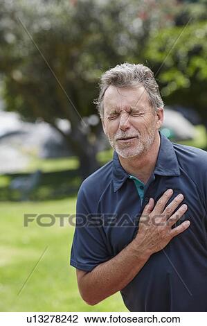Senior man holding his chest in pain View Large Photo Image Stock Image - Senior man holding his chest in pain. Fotosearch