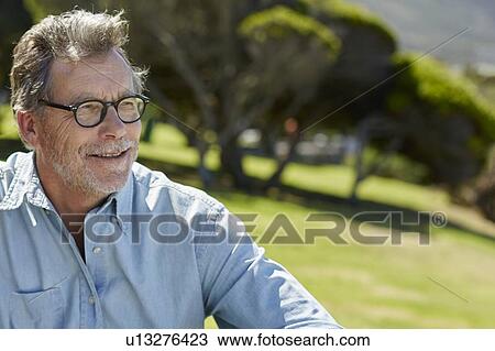 Stock Image - Senior man wearing glasses and shirt. Fotosearch