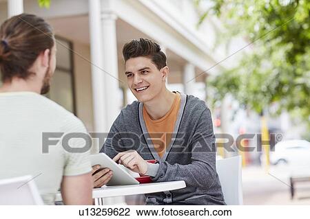 Two male friends with digital tablet View Large Photo Image Stock Image - Two male friends with digital tablet. Fotosearch