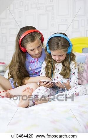 Two sisters in bedroom View Large Photo Image Stock Image - Two sisters in bedroom. Fotosearch
