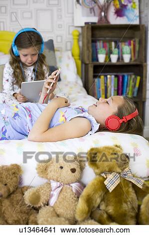 Two sisters in bedroom View Large Photo Image Stock Image - Two sisters in bedroom. Fotosearch