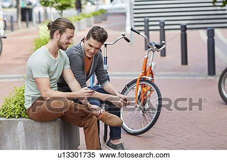 Stock Photography - Two young men with smartphone. Fotosearch
