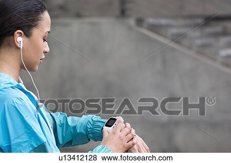 Woman checking watch View Large Photo Image Stock Photo - Woman checking watch. Fotosearch