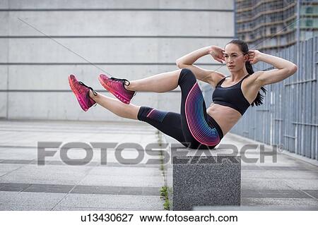 Woman exercising on wall View Large Photo Image Stock Photo - Woman exercising on wall. Fotosearch