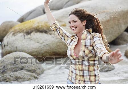 Woman on beach with arms out View Large Photo Image Stock Photo - Woman on beach with arms out. Fotosearch