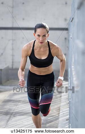 Stock Photography - Woman running towards camera. Fotosearch