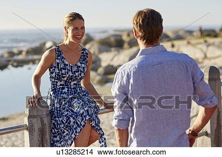 Woman sitting on railings View Large Photo Image Picture - Woman sitting on railings. Fotosearch