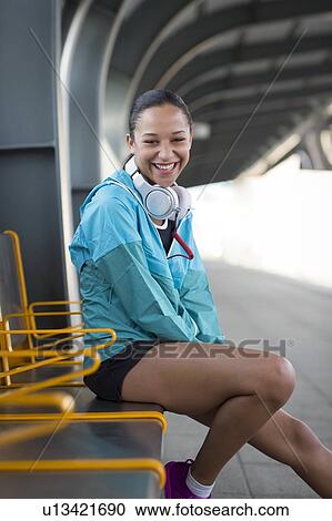 Woman sitting on railway platform smiling View Large Photo Image Stock Image - Woman sitting on railway platform smiling. Fotosearch