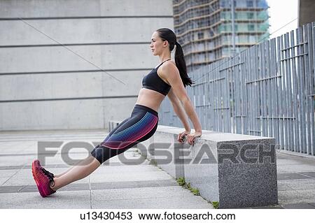 Woman stretching on wall View Large Photo Image Stock Image - Woman stretching on wall. Fotosearch