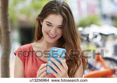 Woman using smartphone View Large Photo Image Picture - Woman using smartphone. Fotosearch