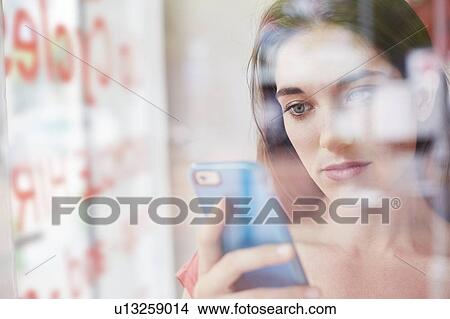 Picture - Woman using smartphone. Fotosearch