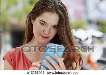 Stock Photography - Woman using smartphone. Fotosearch