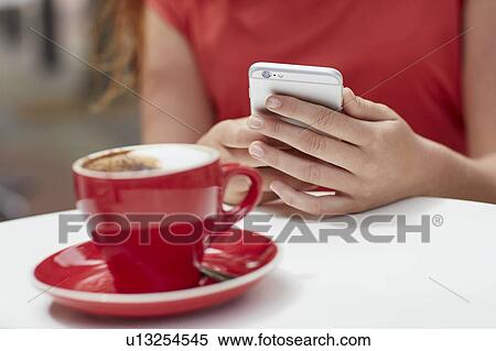 Woman using smartphone with coffee View Large Photo Image Stock Photography - Woman using smartphone with coffee. Fotosearch