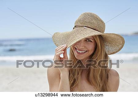 Woman wearing a sunhat View Large Photo Image Picture - Woman wearing a sunhat. Fotosearch