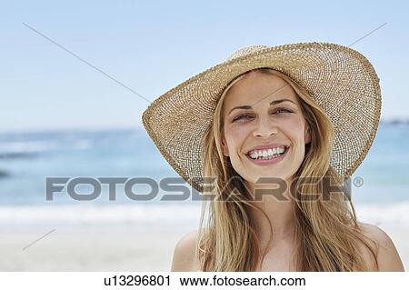 Stock Image - Woman wearing a sunhat. Fotosearch