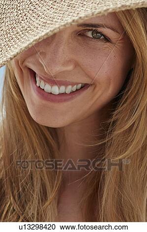 Woman wearing a sunhat View Large Photo Image Stock Image - Woman wearing a sunhat. Fotosearch