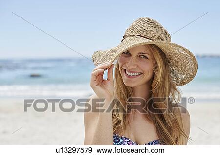 Stock Photo - Woman wearing a sunhat. Fotosearch