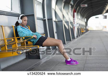 Picture - Woman wearing headphones. Fotosearch