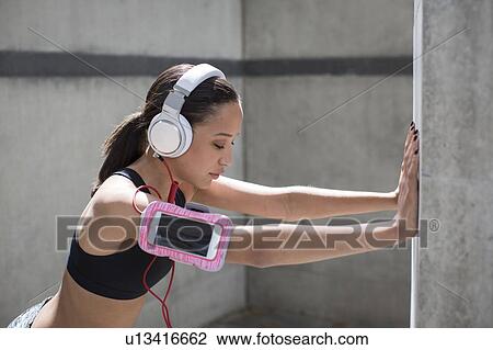 Stock Image - Woman wearing headphones. Fotosearch