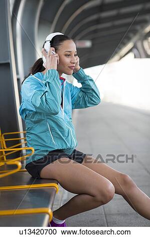 Stock Image - Woman wearing headphones. Fotosearch