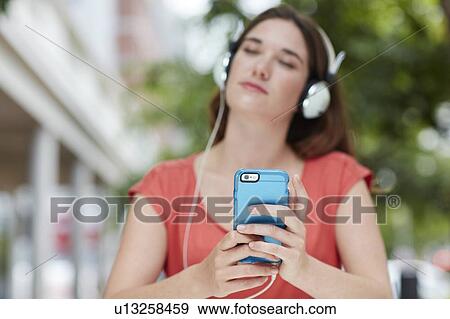 Woman wearing headphones View Large Photo Image Stock Photo - Woman wearing headphones. Fotosearch