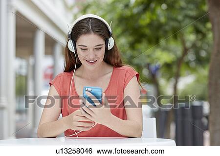 Woman wearing headphones View Large Photo Image Stock Photograph - Woman wearing headphones. Fotosearch