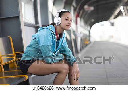 Stock Photograph - Woman wearing headphones. Fotosearch