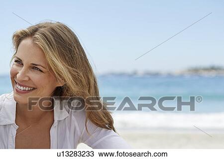 Stock Image - Woman with blonde hair smiling. Fotosearch