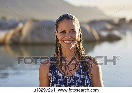 Stock Image - Woman with wet hair smiling. Fotosearch