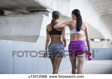 Stock Photo - Women in sports wear walking away. Fotosearch