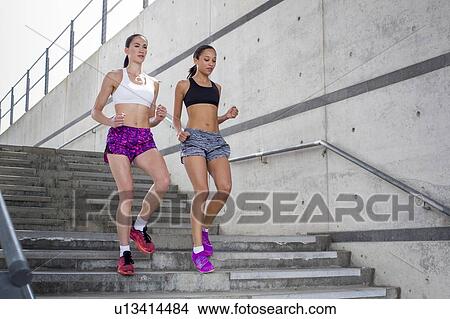 Picture - Women running down steps. Fotosearch