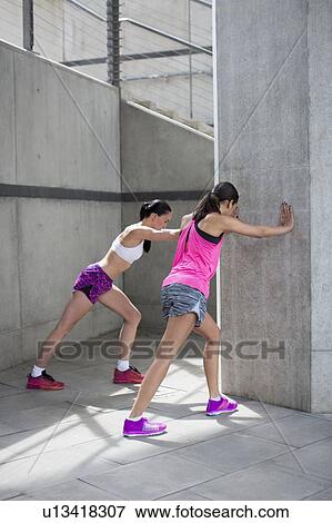 Women stretching against wall View Large Photo Image Stock Photo - Women stretching against wall. Fotosearch