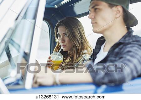 Stock Image - Young couple in a car. Fotosearch