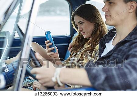 Young couple in a car View Large Photo Image Stock Image - Young couple in a car. Fotosearch