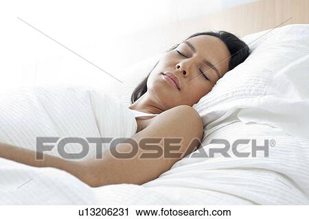 Young woman asleep in bed View Large Photo Image Stock Image - Young woman asleep in bed. Fotosearch