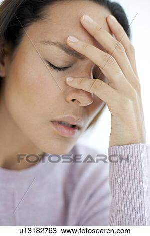 Stock Image - Young woman feeling unwell. Fotosearch