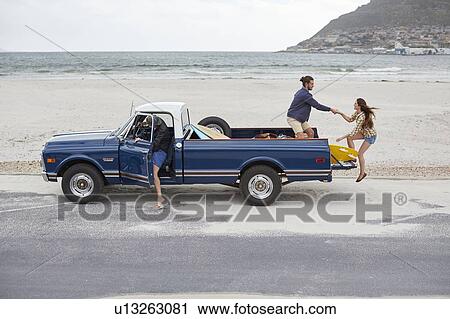 Young woman getting on to pick up truck View Large Photo Image Stock Image - Young woman getting on to pick up truck. Fotosearch